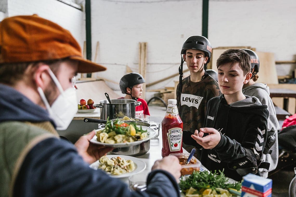 Serving a hot meal to the kids between skate sessions at the skate shelter